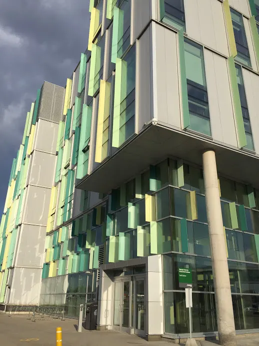 Green and yellow glass panels on the Algonquin Centre for Construction Excellence, above its front entrance