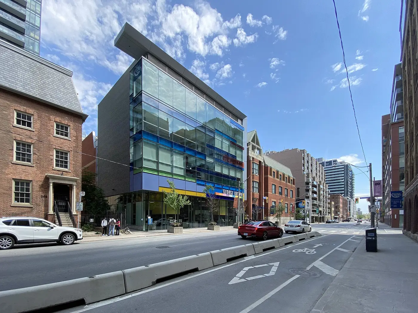 Glass-fronted George Brown Chef School building with blue and green panels on a downtown Toronto street