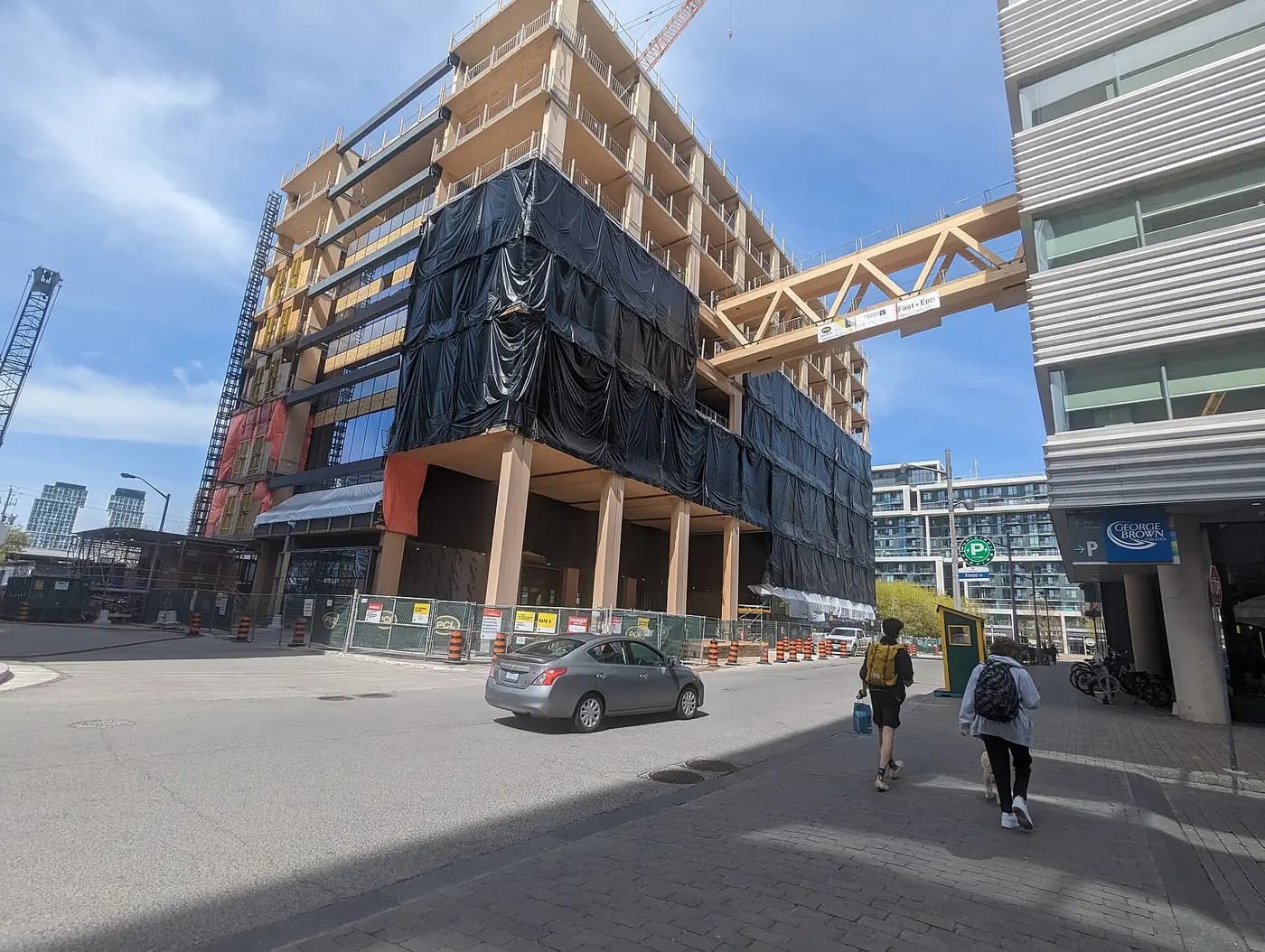 Limberlost Place, a mass-timber building with exposed wooden columns, under construction beside George Brown's Waterfront Campus