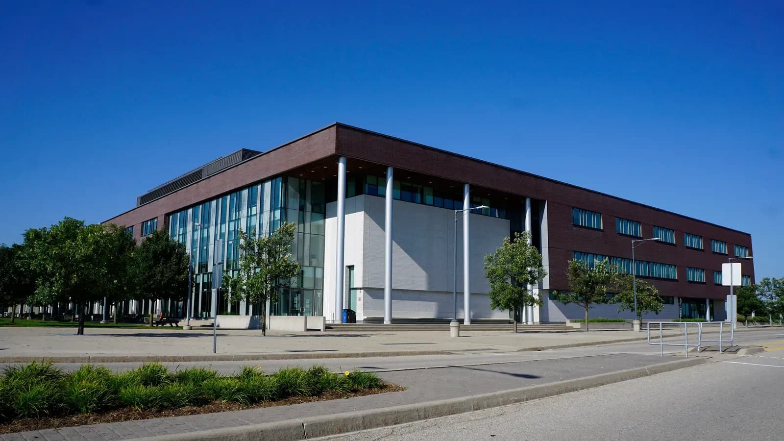 Three-storey brick and glass building with white columns at Conestoga's Cambridge Fountain Street Campus