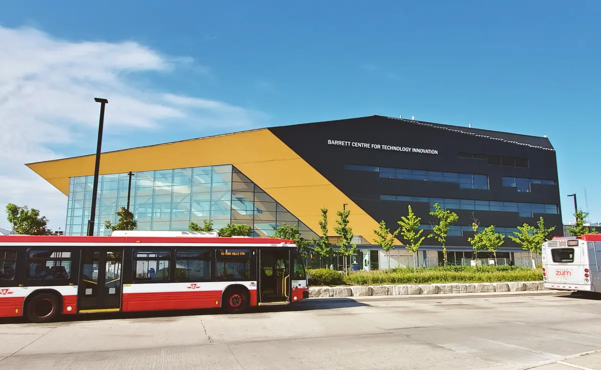 Barrett Centre for Technology Innovation at Humber North Campus, with a TTC bus and a Züm bus at the stop in front