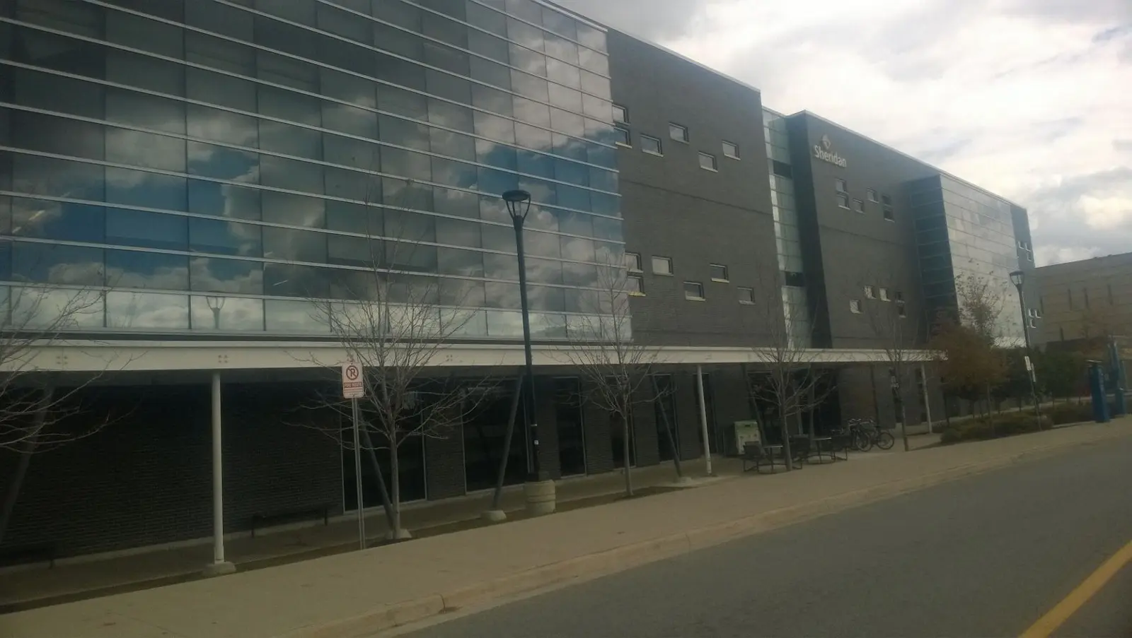 Glass and dark brick exterior of the Davis Campus library building at Sheridan in Brampton
