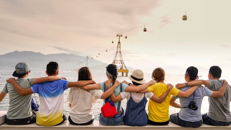 Group of friends sitting arm in arm, supporting one another