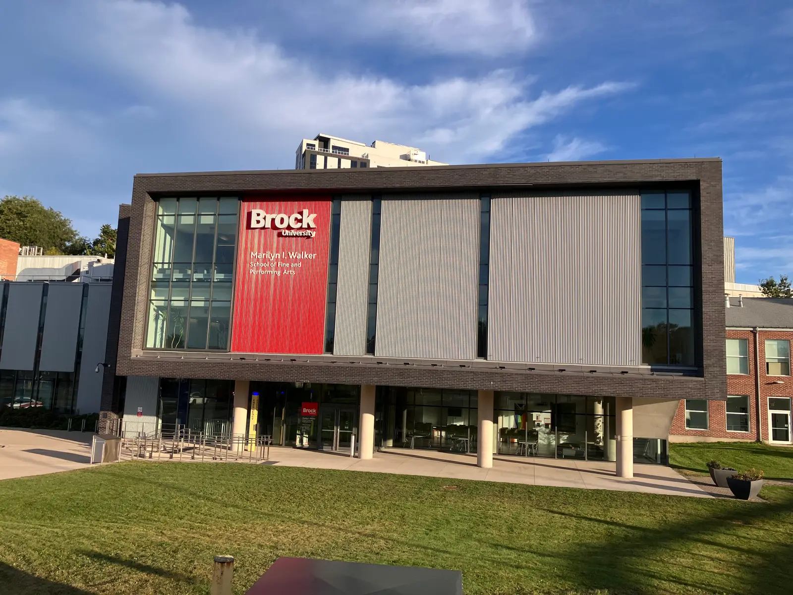 Front of Brock's Marilyn I. Walker School of Fine and Performing Arts in downtown St. Catharines, with a red Brock University banner