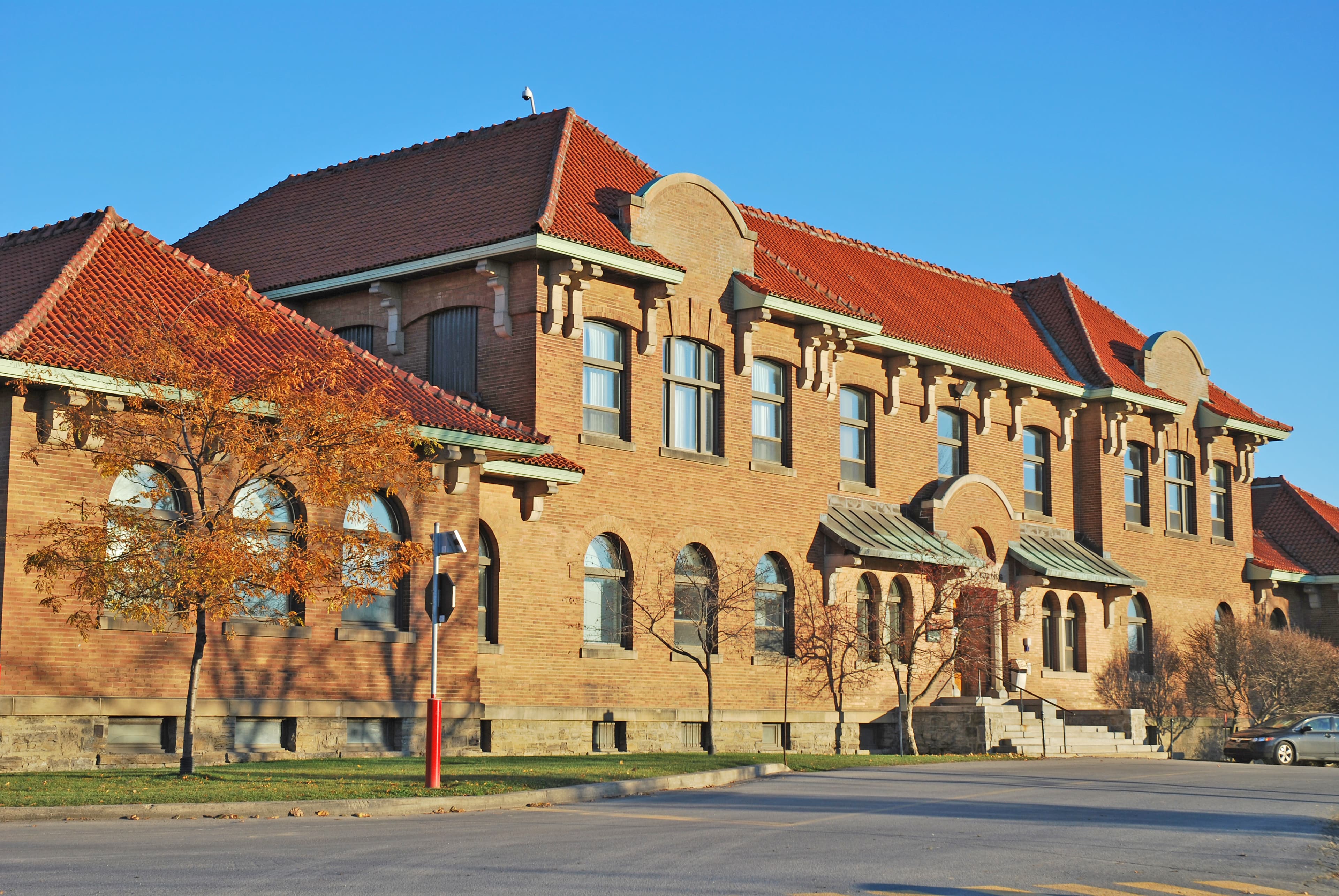 Red-tiled roofs and brick facade of the Agriculture Building at McGill's Macdonald Campus