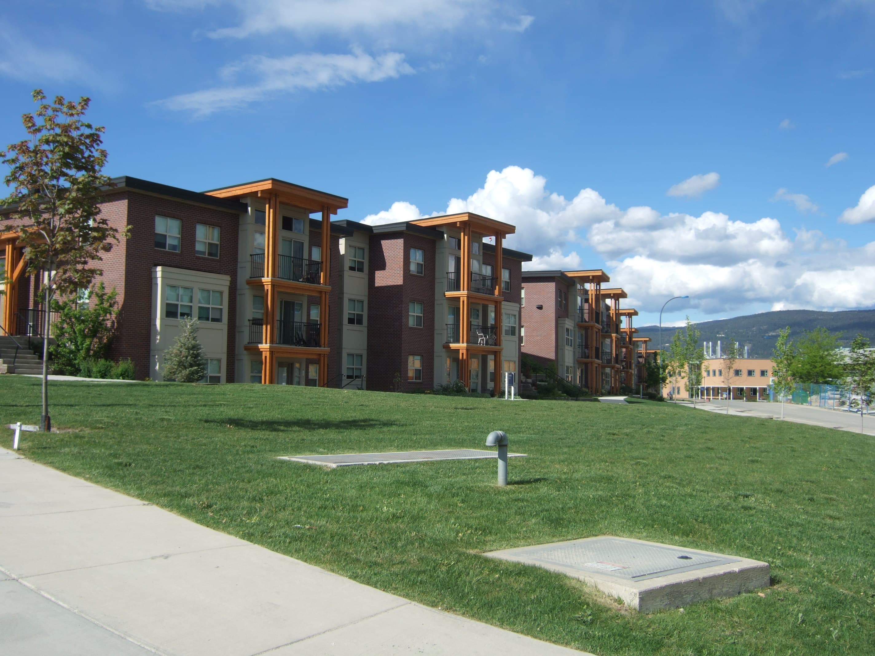 Cascades residence buildings at UBC Okanagan, with balconies above a lawn and campus walkway