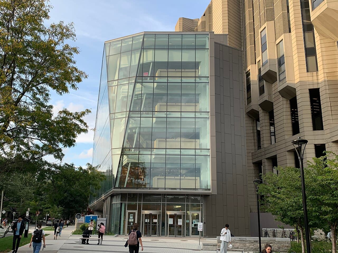 Glass-fronted Robarts Common beside the concrete Robarts Library building at St. George