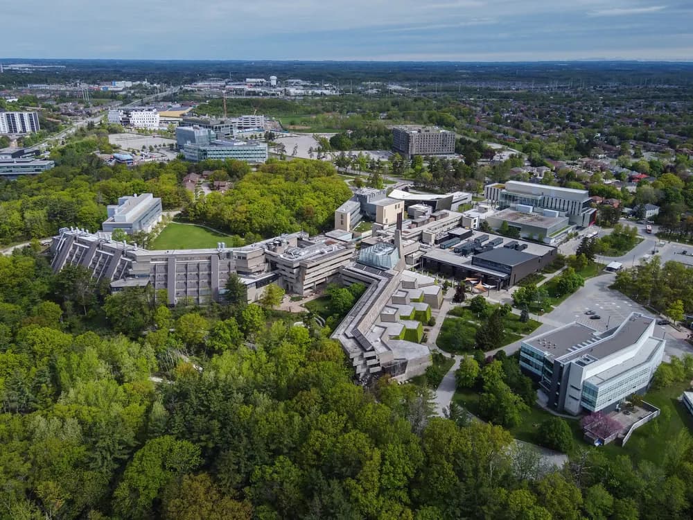 Aerial view of U of T Scarborough's connected campus buildings and surrounding trees