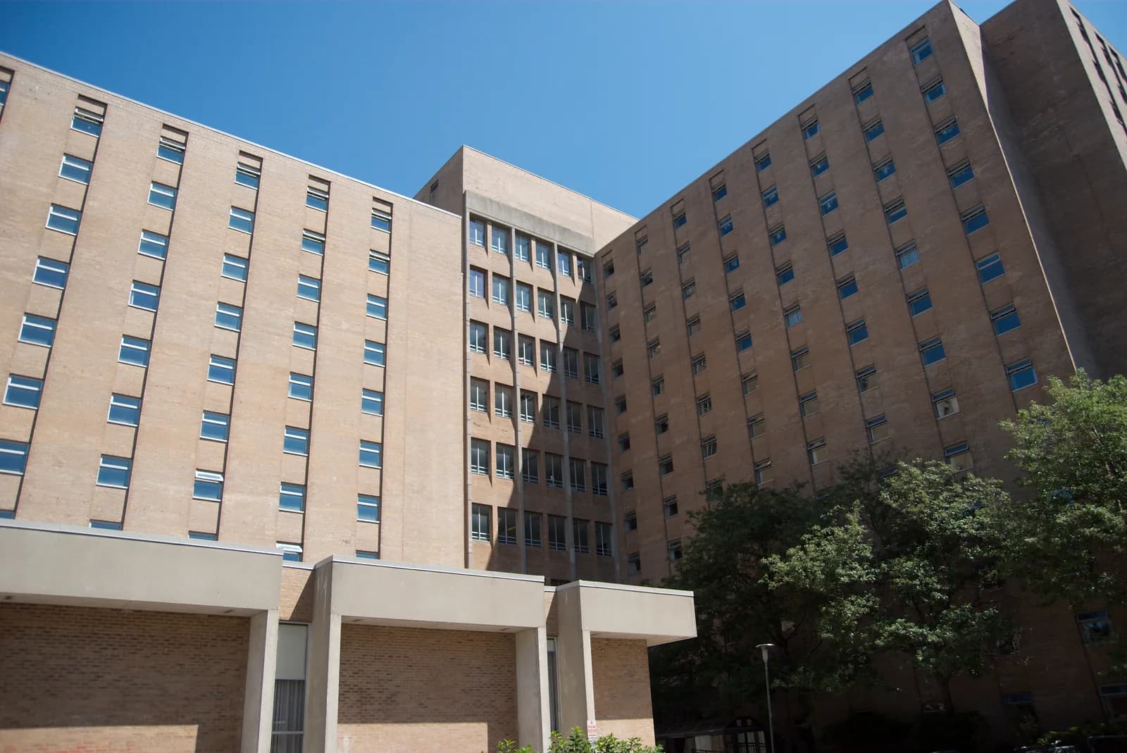 Tan-brick towers of Saugeen-Maitland Hall at Western University under a clear blue sky