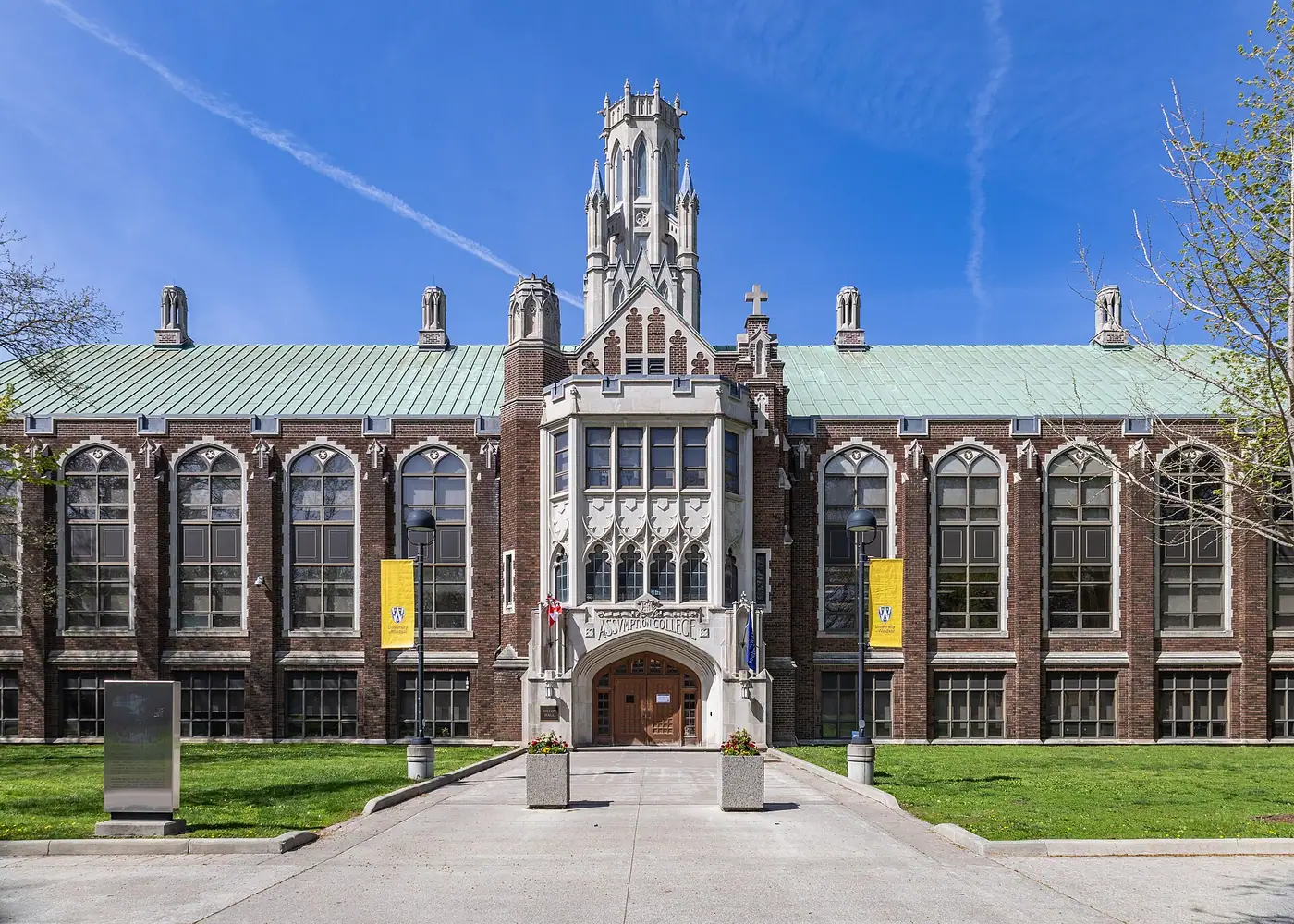Gothic-style brick Dillon Hall on UWindsor's main campus, with a stone tower, tall arched windows and an Assumption College entrance